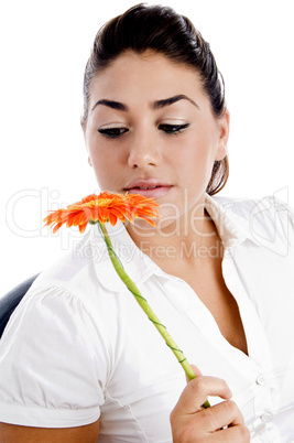 side pose of woman looking the flower