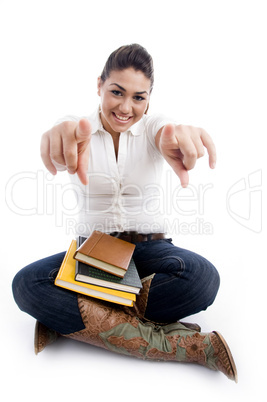 pointing smiling female with books