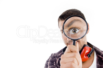 man looking through magnifying glass