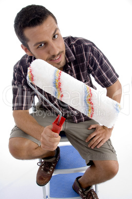 close up view of rolling brush and man holding