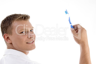 adult caucasian holding toothbrush and posing to camera