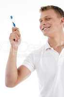 smiling male holding tooth brush