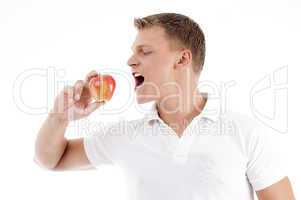 handsome man going to eat apple