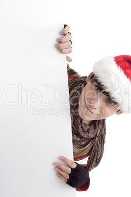 boy wearing christmas hat holding placard