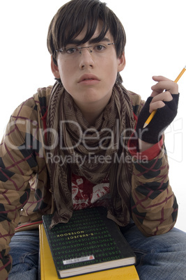 student with pencil and books