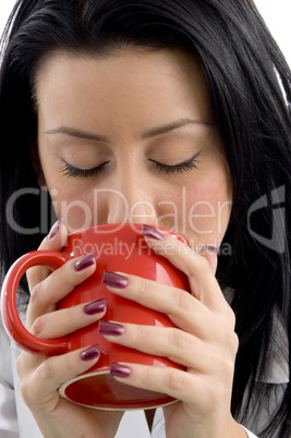 front view of female doctor drinking coffee on white background