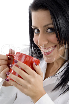 side pose of doctor holding mug on white background