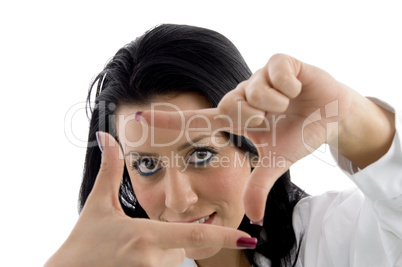 portrait of doctor showing framing hand gesture on white background