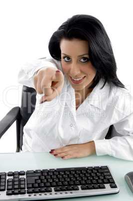 front view of pointing female doctor on white background