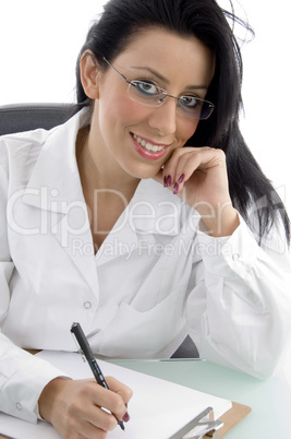 front view of smiling doctor looking at camera on white background