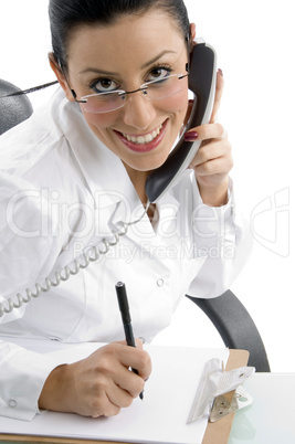 top view of smiling working female doctor on white background