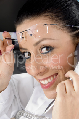 side pose of smiling doctor holding receiver