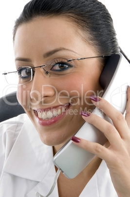 portrait of smiling doctor holding receiver on white background