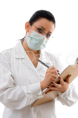 front view of doctor with writing pad and mask on white background