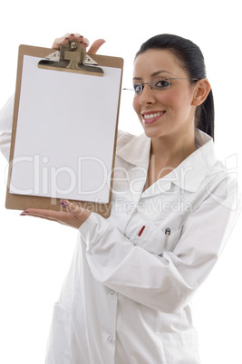 front view of smiling doctor showing writing pad on white background