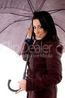side view of smiling woman holding umbrella on white background