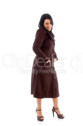 side view of smiling female wearing overcoat on white background