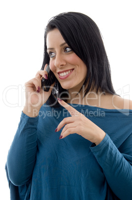 front view of smiling female talking on mobile on white background