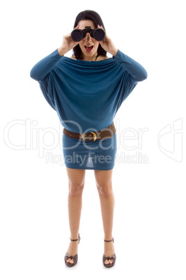 front view of standing woman looking through binocular on white background