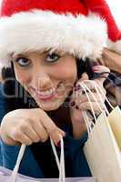 close view of happy christmas woman carrying shopping bags