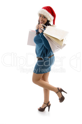 side pose of happy christmas model with shopping bags