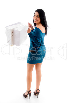 side view of female with shopping bags on white background