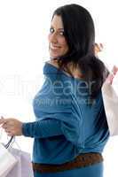 back pose of smiling model with carry bags