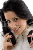 front view of smiling female holding headphone