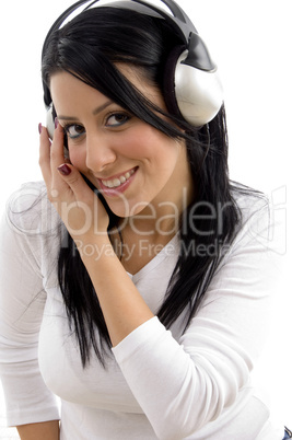 front view of cheerful woman listening music