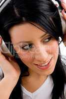 close view of model holding headphone