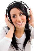 front view of happy model listening music on white background
