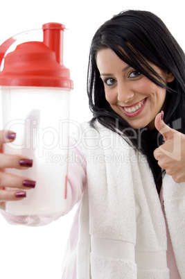 portrait of smiling woman with water bottle showing thumb up