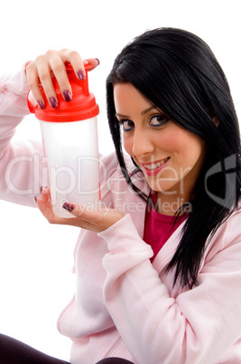 front view of smiling female holding water bottle on white background