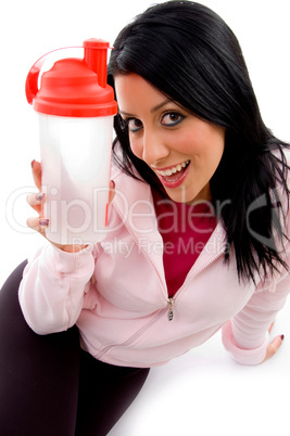 front view of smiling female with bottle on white background