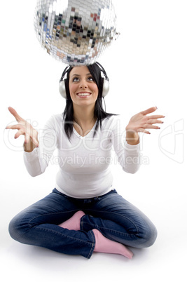 front view of smiling female playing with disco mirror ball