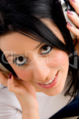 top view of female holding headphone on an isolated background