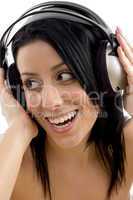 close up of smiling woman holding headphone