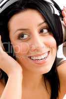 close up of smiling female enjoying music on an isolated background