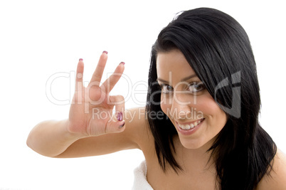 portrait of adult woman showing ok sign