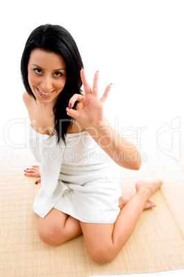 top view of woman showing ok sign against white background