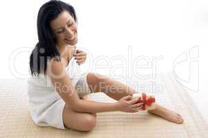 front view of smiling woman scrubbing her legs
