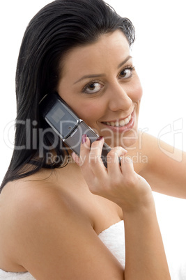 side view of smiling woman talking on cell phone