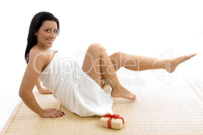 front view of woman in towel posing with scrubber