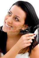 portrait of woman combing her hair on white background