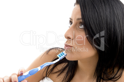 portrait of female looking upward with toothbrush