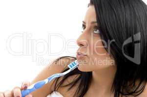 portrait of female looking upward with toothbrush
