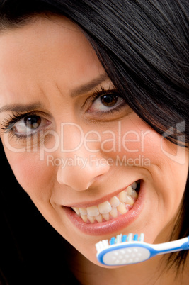 close up of woman brushing her teeth with white background
