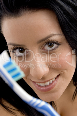 close up of woman showing toothbrush