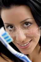 close up of woman showing toothbrush