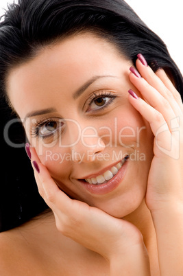 portrait of smiling woman touching her face on white background